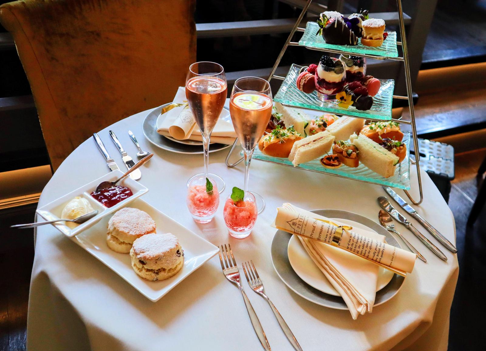Afternoon tea and sparkling wine arranged on a round table